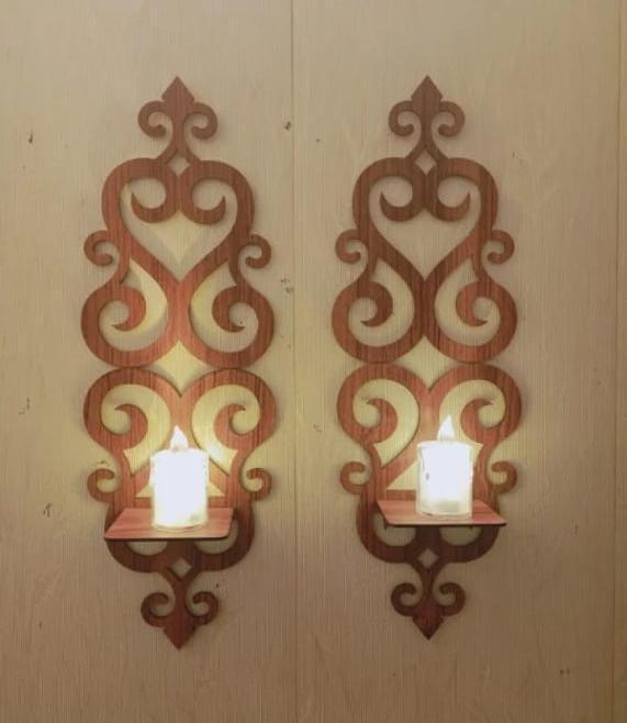 Wall-mounted candle holders with scrollwork design, golden metal